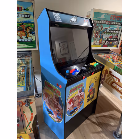 Vintage arcade game machine with joystick and buttons, decorated with colorful cartoon side panels.
